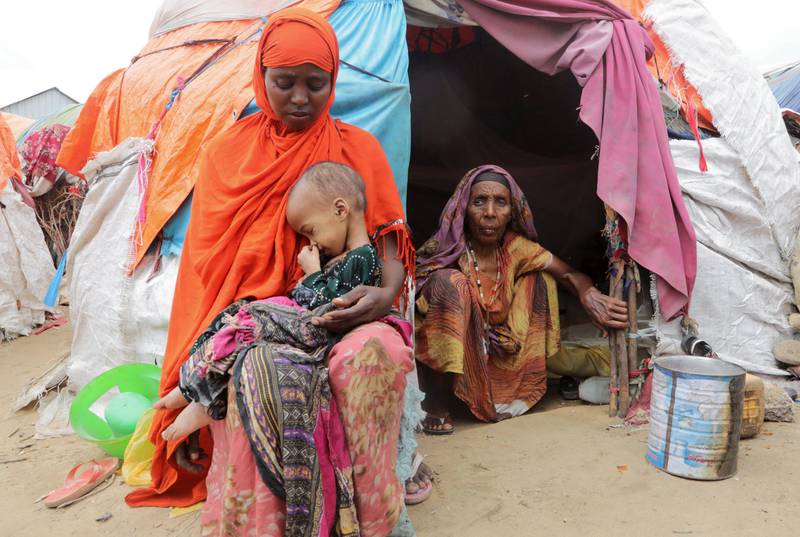 Buney Aayow Ibrahim holds her child, Sadia Salas Abdi, 3, outside their makeshift shelter at the Alla Futo camp for internally displaced people on the outskirts of Mogadishu, Somalia. All photos by Reuters