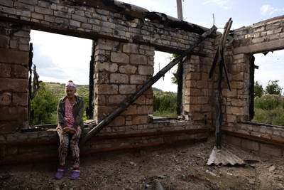 Widow Lubov Doroshenko, 67, returns to her destroyed home  in Bohorodychne, Donetsk region, eastern Ukraine, in July. Getty Images