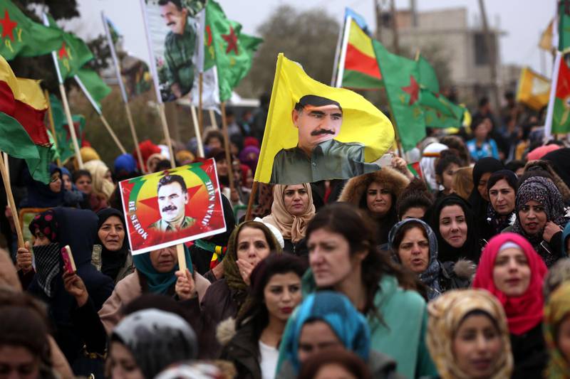 TOPSHOT - Syrian-Kurds carry portraits depicting jailed founding member and leader of the Kurdistan Worker's Party (PKK) Abdullah Ocalan, as they march during a protest in support of Afrin on January 18, 2018, in the northern Syrian town of Jawadiyah.
Turkish President Recep Tayyip Erdogan earlier in the week vowed to soon launch an operation against towns in Syria held by the Kurdish People's Protection Units (YPG), which Ankara considers "terrorists". / AFP PHOTO / Delil souleiman
