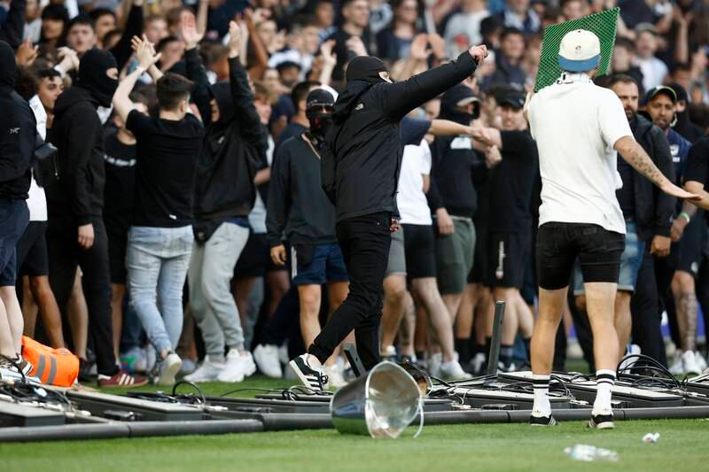 Supporters storm the pitch in protest. Getty