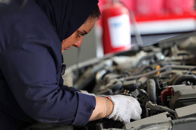 Angham Jeddawi works on a car at the service centre, Petromin Express garage.  