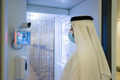Temperature scanning at a sanitisation booth. Courtesy of Etihad Airways.