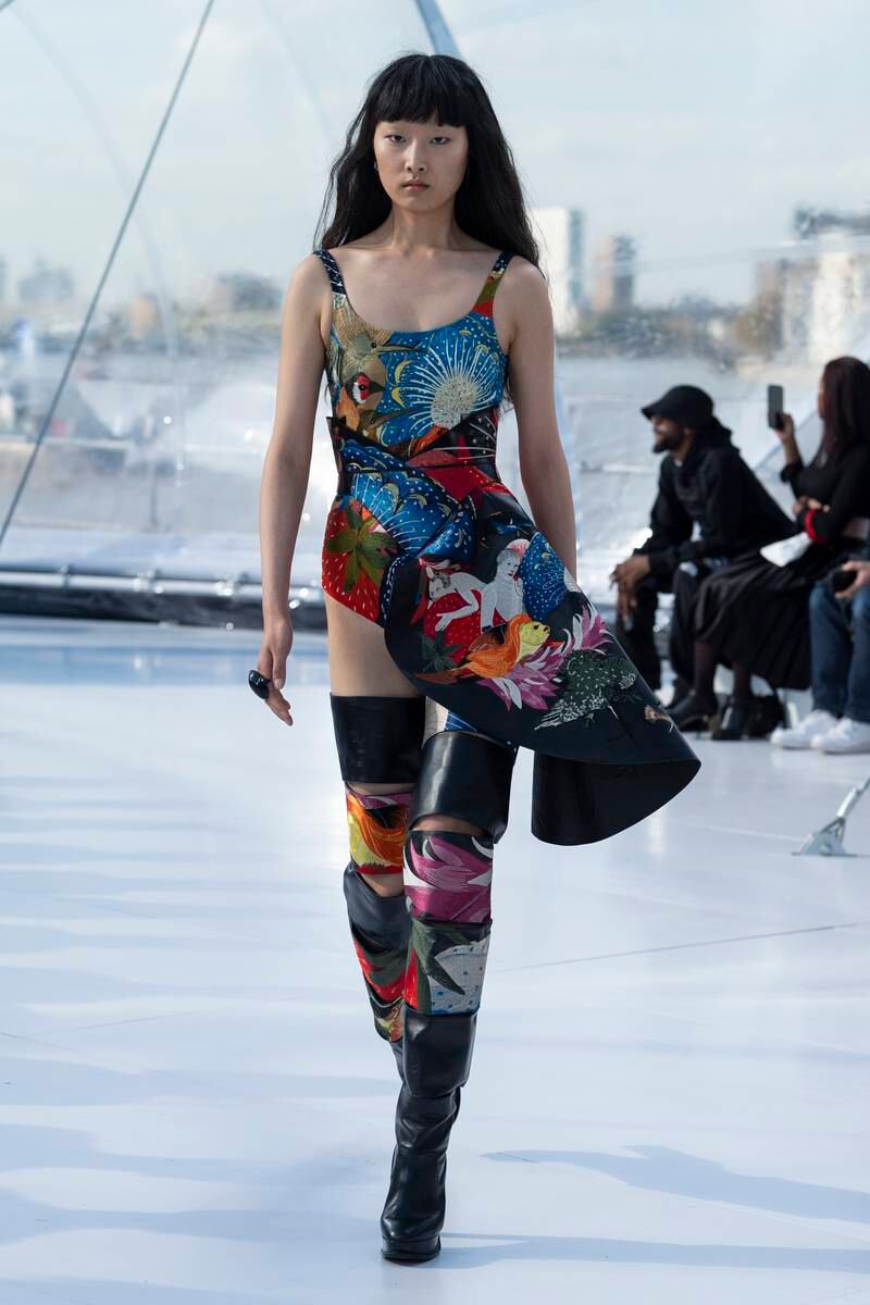 Multi-hued forms inspired by the works of Hieronymous Bosch were hand-embroidered onto leather skirts and thigh-high boots.