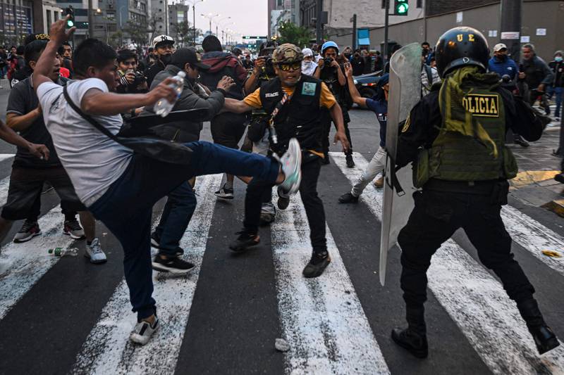 Supporters of Peruvian former President Pedro Castillo clash with riot police during a demonstration demanding his release and the closure of the Peruvian Congress, in Lima. AFP