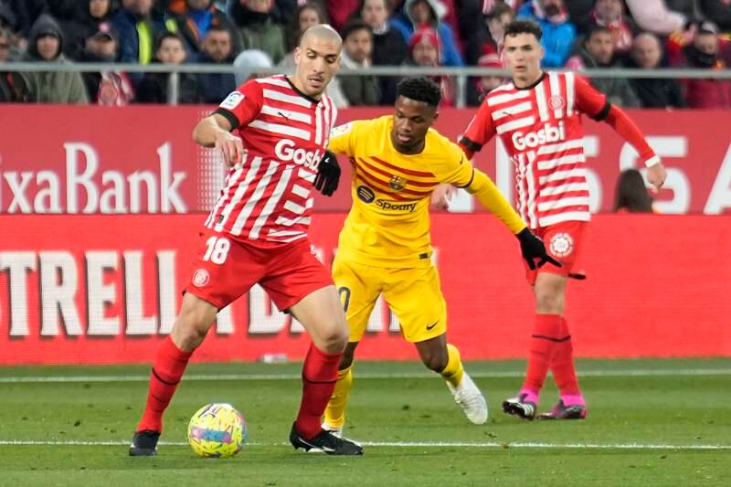 Girona midfielder Oriol Romeu battles for the ball with Barca striker Ansu Fati. EPA