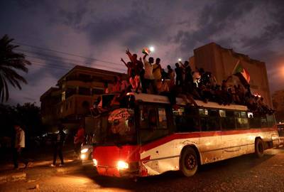Sudanese people gather on a bus as they celebrate.  EPA/MORWAN ALI
