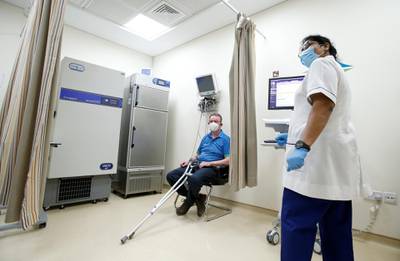 A man waits to receive the first of two doses at Zabeel Health Centre in Dubai on 27 December, 2020.