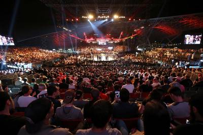 Fans watch the featherweight bout between Jim Alers and Alan Omer at du Arena in Abu Dhabi on April 11, 2014. Pawan Singh / The National