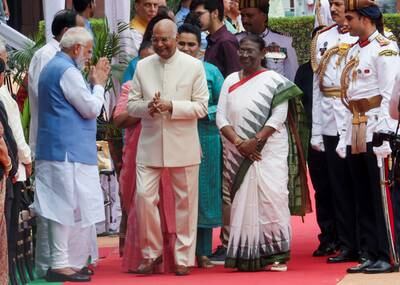 India's Prime Minister Narendra Modi, left, greets President Droupadi Murmu, third from left, and her predecessor Ram Nath Kovind, centre, in New Delhi. Reuters