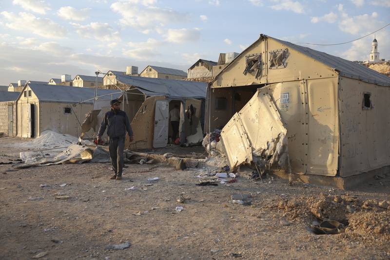 The aftermath of shelling is seen in Maram camp on Sunday. AP