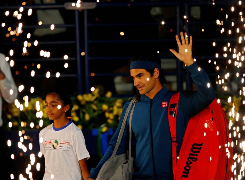 Federer and Tsitsipas arrive on court before the game starts. EPA