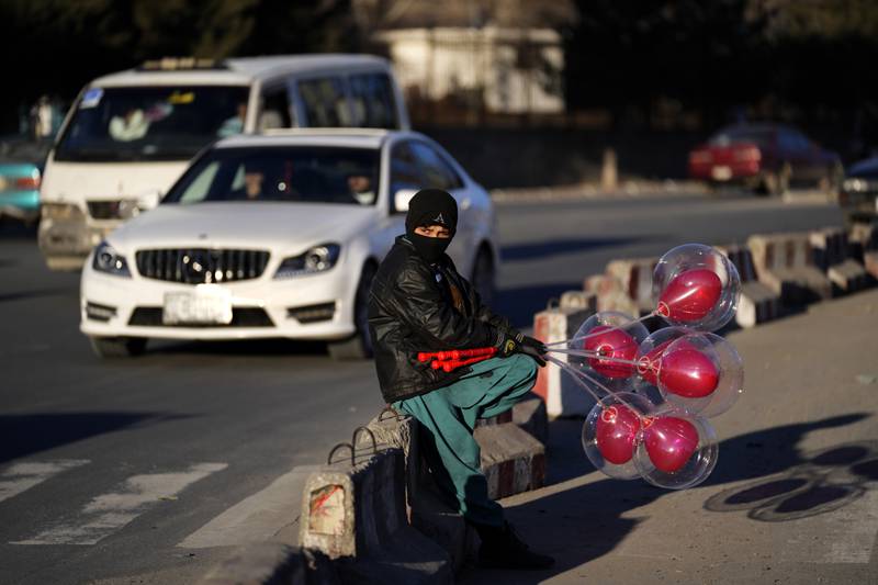An Afghan street vendor waits for customers before Valentine's Day in Kabul. AP