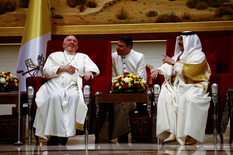 Pope Francis laughs during his meeting with King Hamad. Reuters