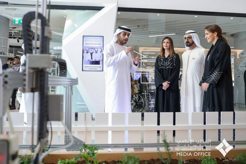 Sheikh Mohammed bin Rashid listens to a presentation with Tamkeen chairman Rima Al Mokarrab and food minister Mariam Al Mehairi. Courtesy: Dubai Media Office