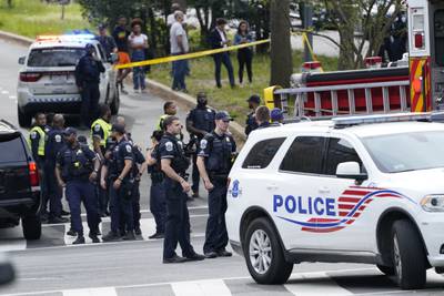 Police respond near the scene of the shooting. AP
