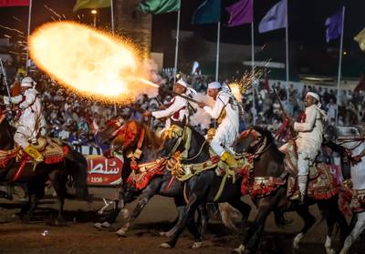 Moroccan horsemen fire their rifles during a performance to celebrate the annual Moussem festival in El Jadida on August 6, 2023.  (Photo by Fadel SENNA  /  AFP)