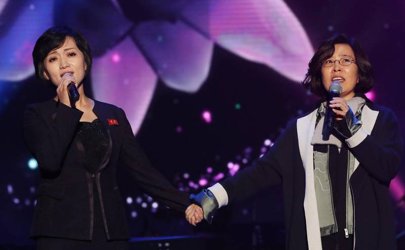 South Korea's Lee Sun-hee, right, and North Korea's Kim Ok-ju, left, sing together during a performance of a joint inter-Korean concert. EPA / Korea Pool