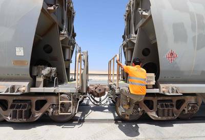 An Etihad Rail technician at work on a train at Al Mirfa. Greenhouse gases will be slashed by more than 2.2 million tonnes a year once the network is fully operational. AFP