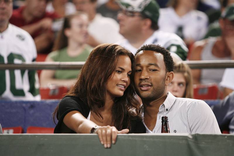 Teigen and John Legend in the stands during a National Football League pre-season game between the New York Giants and the New York Jets in East Rutherford, New Jersey, on August 23, 2008. Reuters