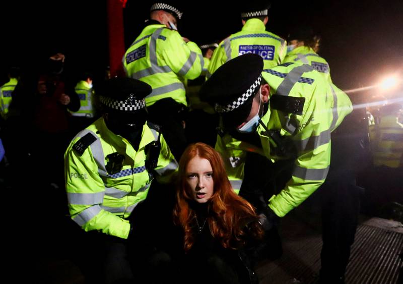 Police detain student protester Patsy Stevenson in London, on March 13, as people gather at a memorial site, after the kidnap and murder of Sarah Everard. Reuters