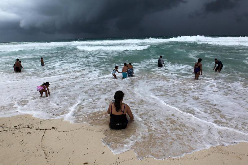 People swim in the turbulent sea at a beach in Cancun, Quintana Roo, Mexico. EPA