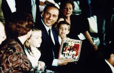 Berlusconi, president of AC Milan, his mother Rosa Bossi, right, and his children Eleonora and Luigi hold a pennant celebrating the club winning their 12th Serie A title in 1992. Getty Images