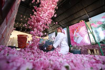 A worker at the Bin Salman farm tosses freshly picked roses in the air. AFP
