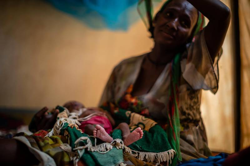 Abeba Gebru, 37, from the village of Getskimilesley, sits with her malnourished daughter, Tigsti Mahderekal, 20 days old, in the treatment tent of a medical clinic in the town of Abi Adi, in the Tigray region of northern Ethiopia. AP Photo