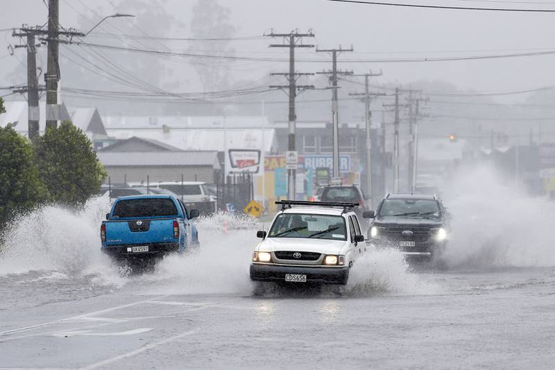 Cars negotiate flooded roads in the northern New Zealand city of Whangarei.  AP