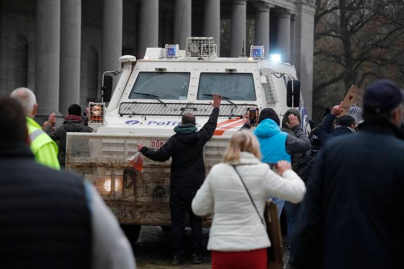 People block a police vehicle. EPA