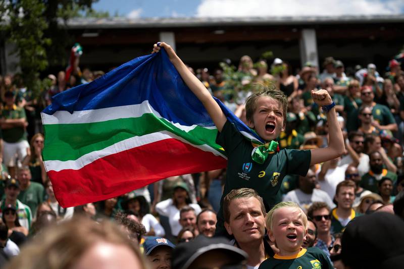 South African fans celebrate at the Pirates Rugby Club in Johannesburg, South Africa after their team's victory in the Rugby World Cup final between South Africa and England being played in Tokyo, Japan.  South Africa defeated England 32-12. AP Photo