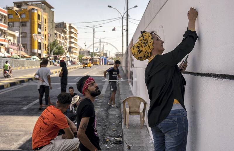 A group of volunteers help to fix artworks and paint new ones in Al Sadoon tunnel next to Tahrir square preparing for the anniversary of the protests. Haider Husseini for The National