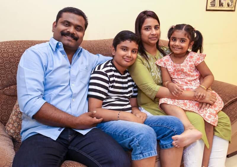 Tibin Mathew and wife, Seenamol Varkey, with their children, Rishon and Angel Maria, in their Abu Dhabi home. All photos: Victor Besa / The National