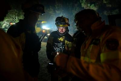 Firefighters work to extinguish wildfires in forest near the town of El Rosario in Tenerife, Canary Islands, Spain. AP Photo