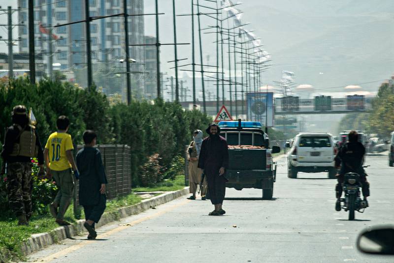 Taliban fighters stand guard along a road near the Russian embassy after a suicide attack in Kabul on September 5, 2022. AFP