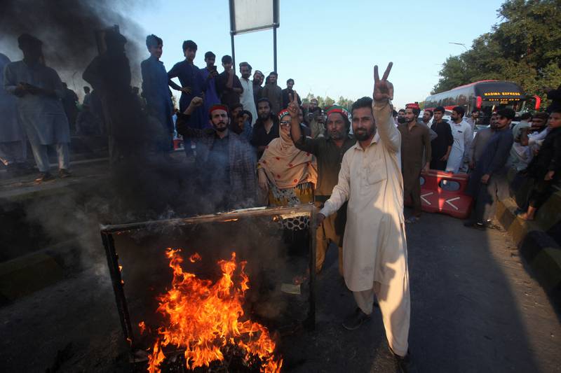 Protesters chant slogans as they block the main highway in Peshawar. Reuters