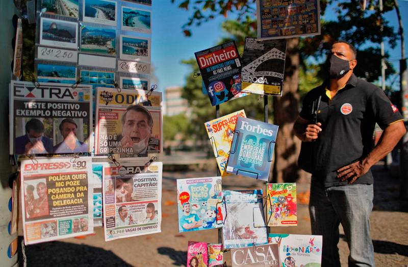 A man looks at the front pages of newspapers in Rio de Janeiro, Brazil.  AFP