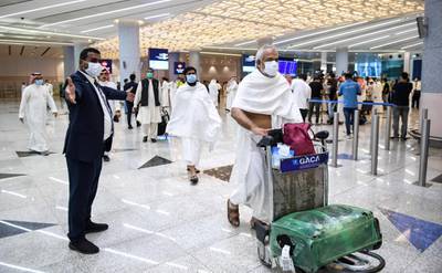 Mask-clad Pakistani travellers arriving in Saudi Arabia. AFP