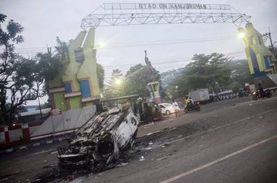 A torched car outside Kanjuruhan Stadium. AFP