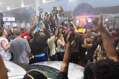 Demonstrators take over a service station after being chased off an interstate motorway, near a Wendy's restaurant that was destroyed after the shooting of Rayshard Brooks, 27, at the restaurant in Atlanta, Georgia.  EPA