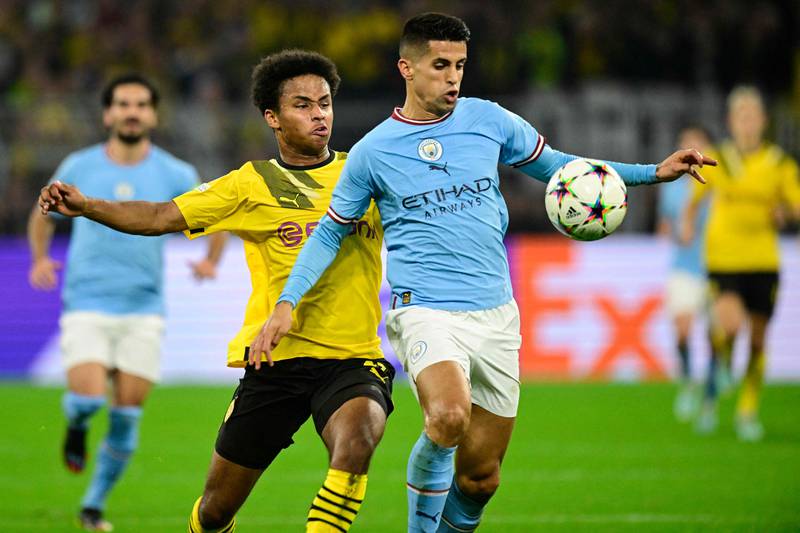 Dortmund's Karim Adeyemi and Manchester City's Joao Cancelo. AFP