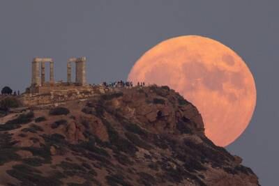 A full moon known as the blue supermoon rises behind the Temple of Poseidon, in Cape Sounion, near Athens. Reuters
