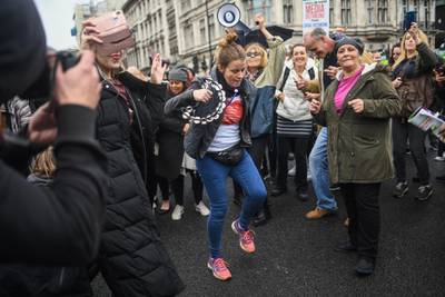 Protesters are seen dancing in Parliament Square during a Unite for Freedom march in London. Getty Images