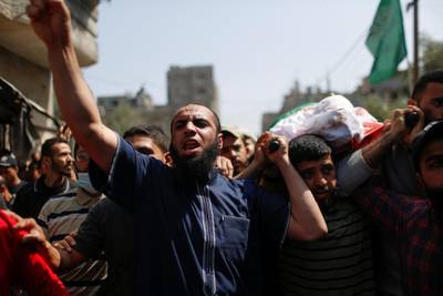 Mourners carry the body of Ahmed Al Shenbari, a Palestinian, during his funeral in the northern Gaza Strip. Reuters