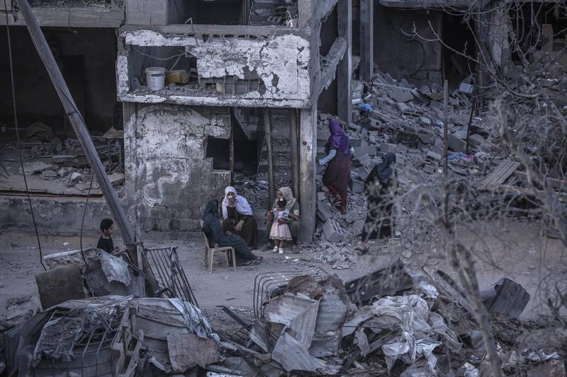Palestinians sit amid the rubble of destroyed homes in Beit Hanoun, northern Gaza, on May 22, 2021. Getty