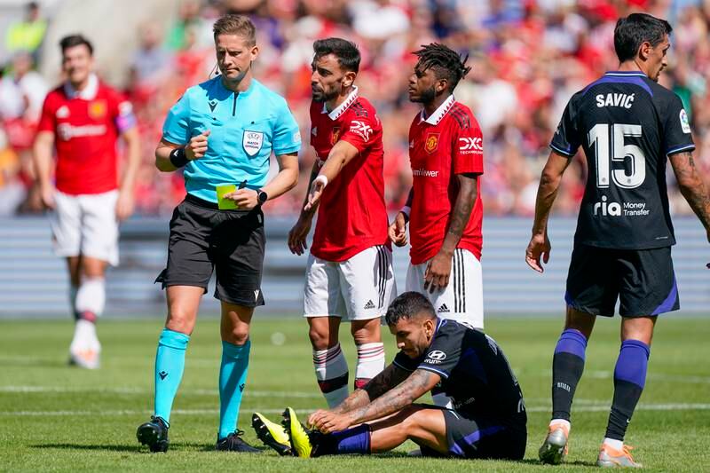 Manchester United's Bruno Fernandes and Fred talk with referee Espen Eskas. EPA