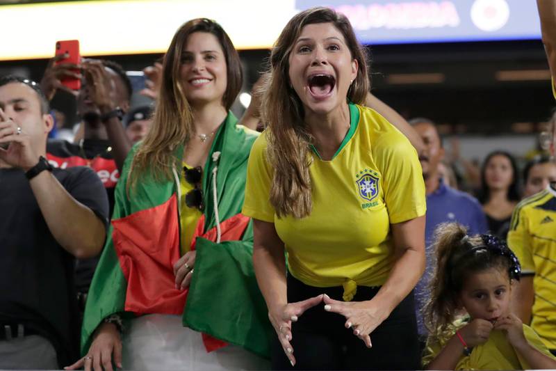 A Brazil fan screams as Brazil forward Neymar walks on the field before the match. AP Photo