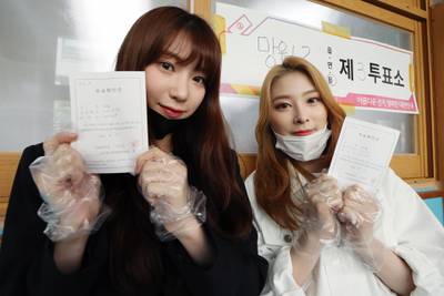 Soo Yoon and Yoon Kyung, members of South Korean girl group Rocket Punch, pose for a photo after casting their ballots for the general elections at a polling station in Seoul, South Korea.  EPA
