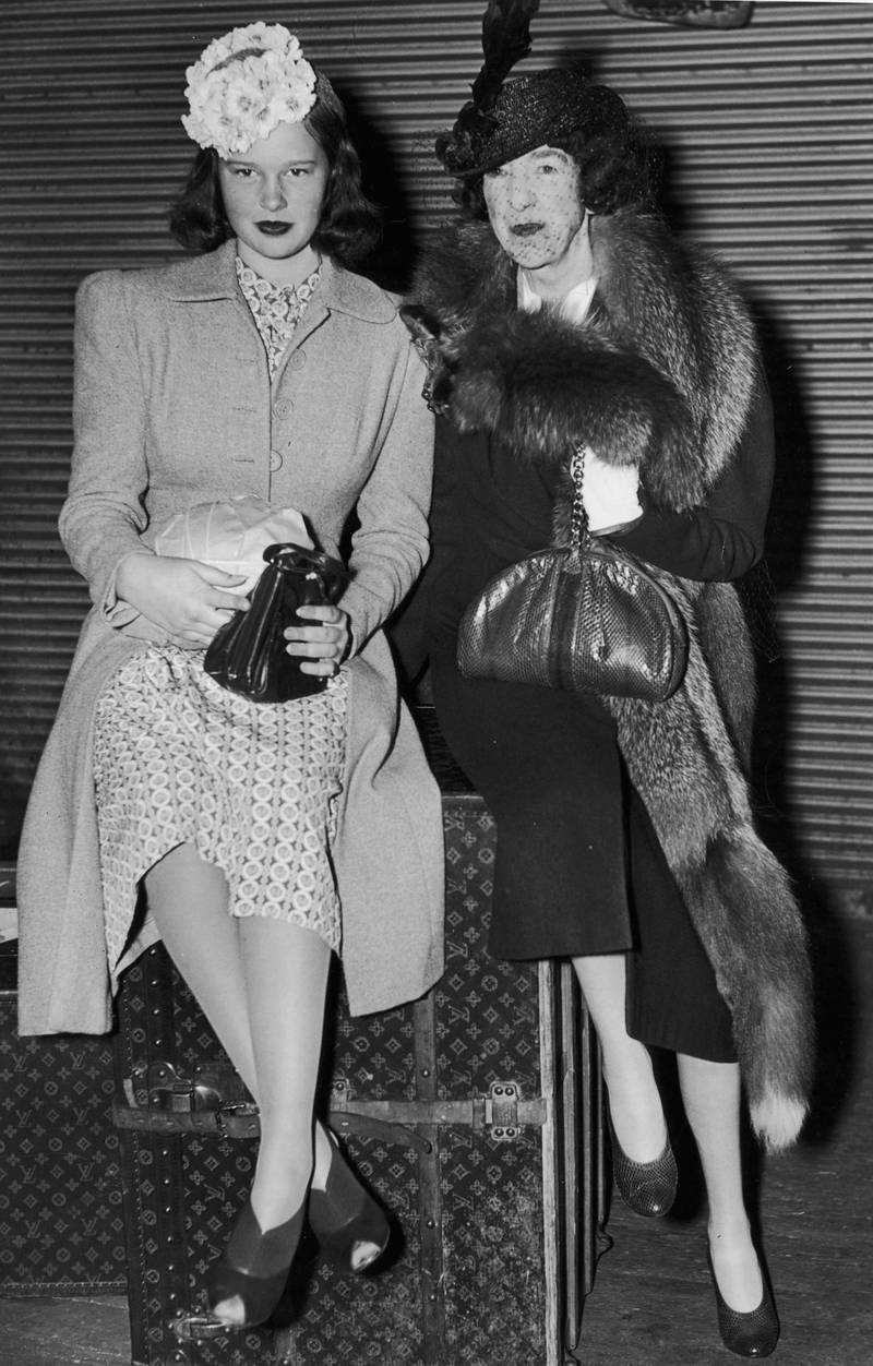 American heiress Gloria Vanderbilt and her aunt sit on top of a Louis Vuitton trunk in 1945