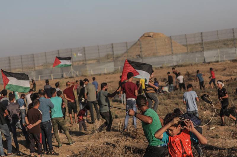 Palestinian protesters attend weekly Friday protests near the border between Israel and Gaza Strip. EPA